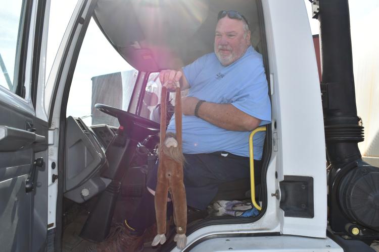 City of Hickory street sweeper operator Dan with his mascot in the street sweeper cab