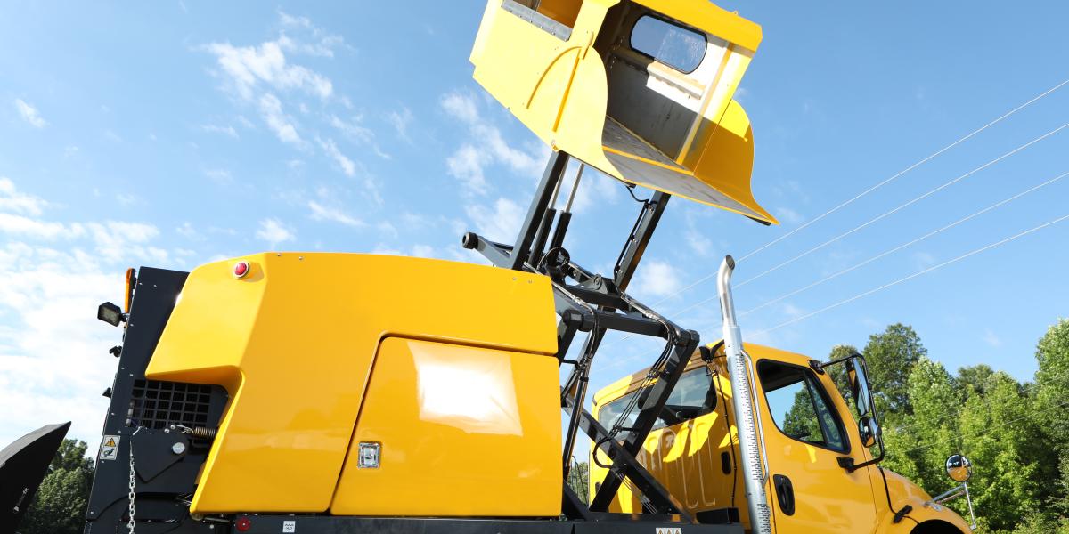 E35m yellow mechanical truck mounted sweeper hopper raised close up