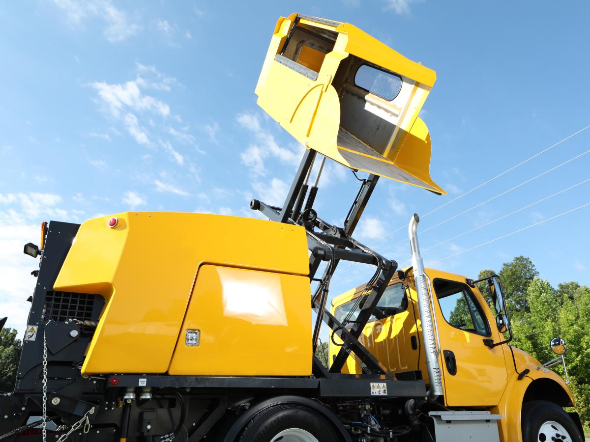 E35m yellow mechanical truck mounted sweeper hopper raised close up