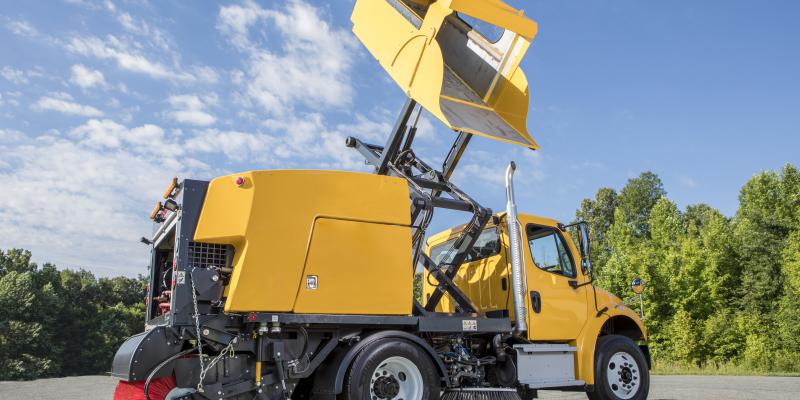 E35m yellow truck mounted street sweeper hopper raised and tilted